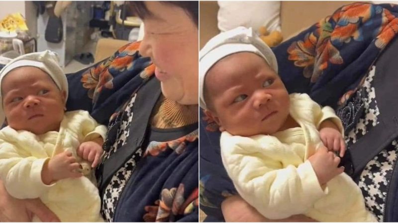 Grandma’s Endearing Embrace: A Delightful Showcase of the Baby’s Adorable and Hilarious Expressions That Will Leave You in Stitches!